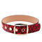 Ceinture léopard à oeillets rouge.