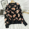 Pull amour léopard noir et beige.