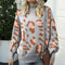 Pull gris léopard col roulé.